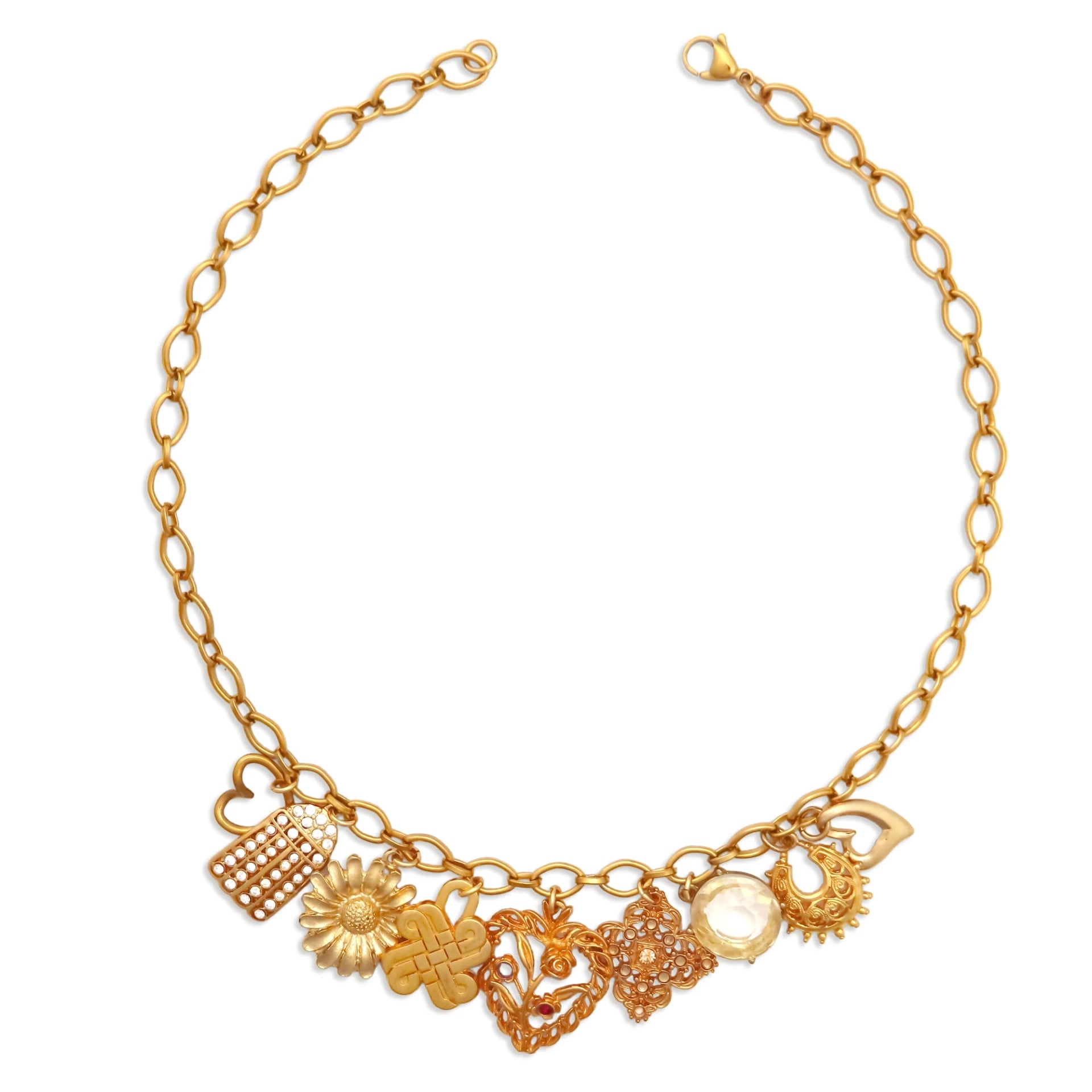 Woman wearing an 18k gold plated link necklace with a cluster of heart, knot, and crystal charms, by Enleira
