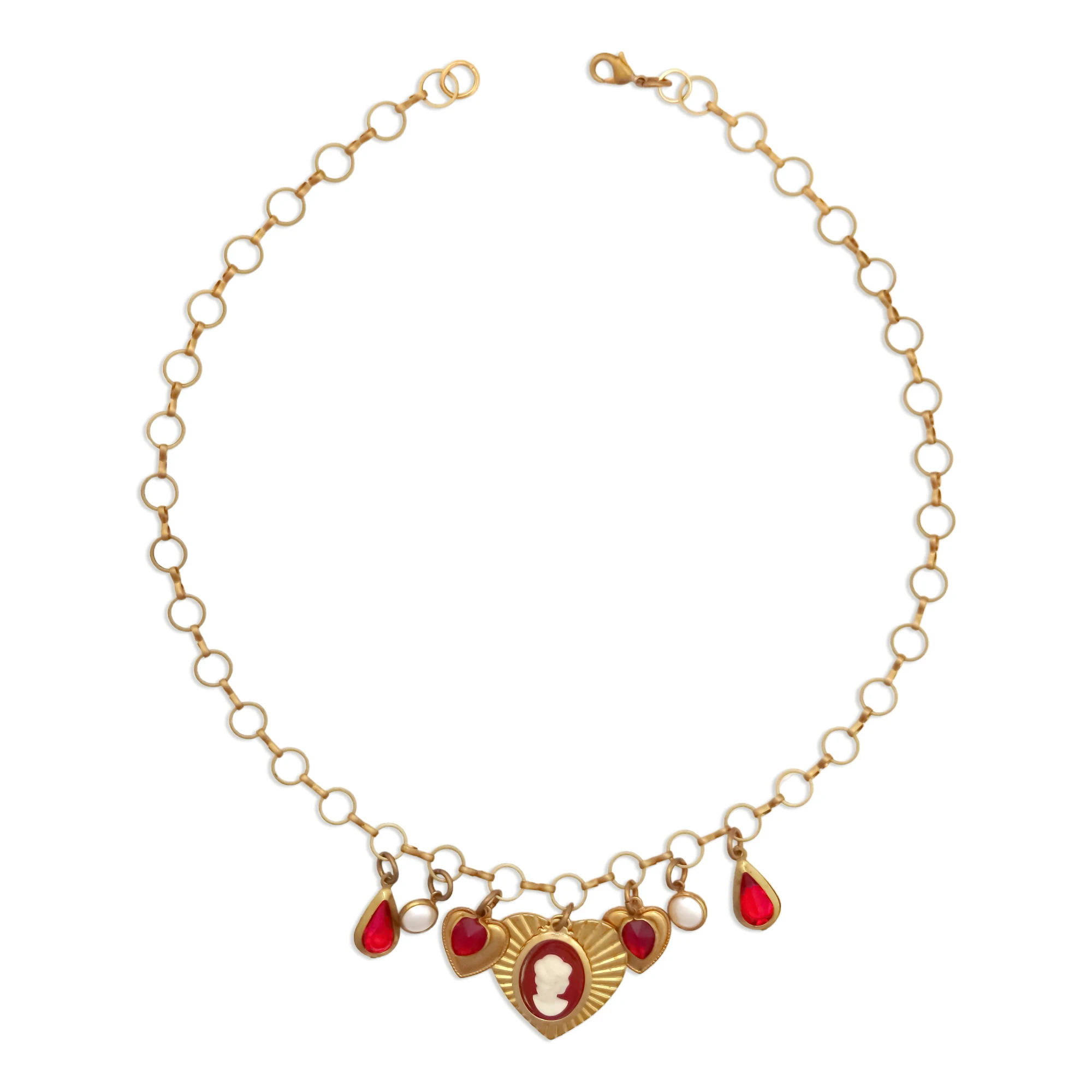 Vintage-style brass charm necklace with a red cameo, pearl, and heart charms on a woman's neck, by Enleira